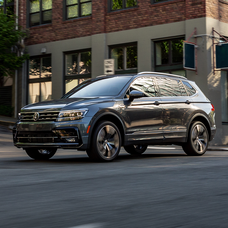 blue Volkswagen tiguan suv cruising through the city