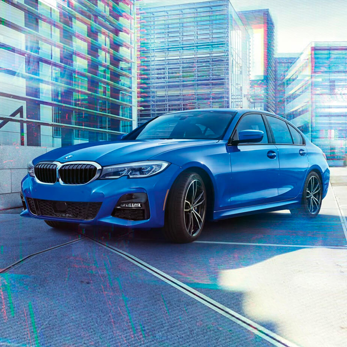 side profile BMW sedan parked in front of a construction building