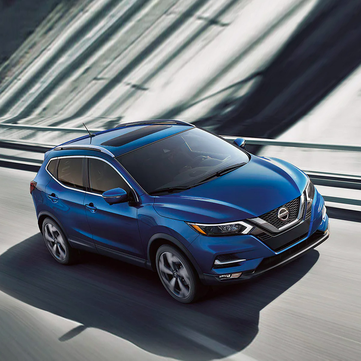 2021 nissan rogue sport driving down the highway