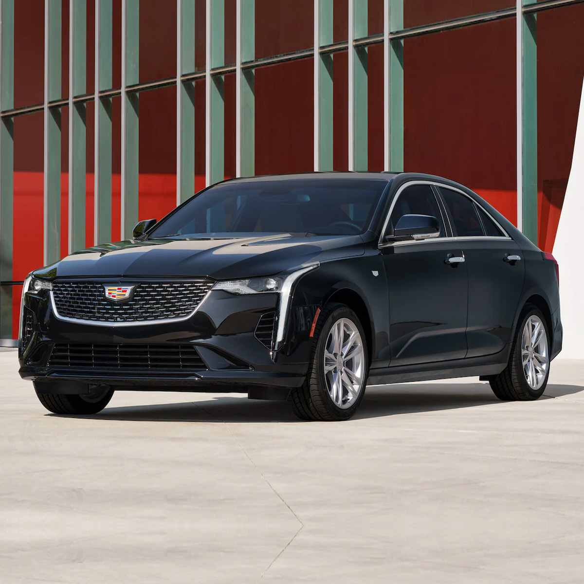 2022 Cadillac CT4 parked in front of a modern building
