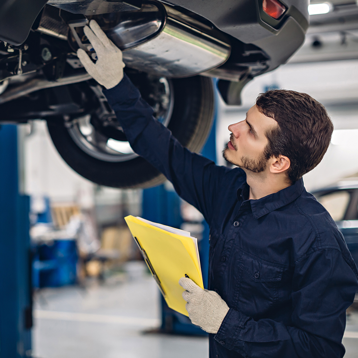 Service team member inspecting a vehicle